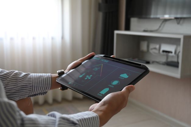 cropped-image-hands-are-using-tablet-with-home-devices-controlled-applications-screen