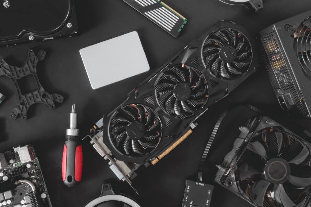 top-view-computer-parts-with-harddisk-ram-cpu-graphics-card-motherboard-black-table-background